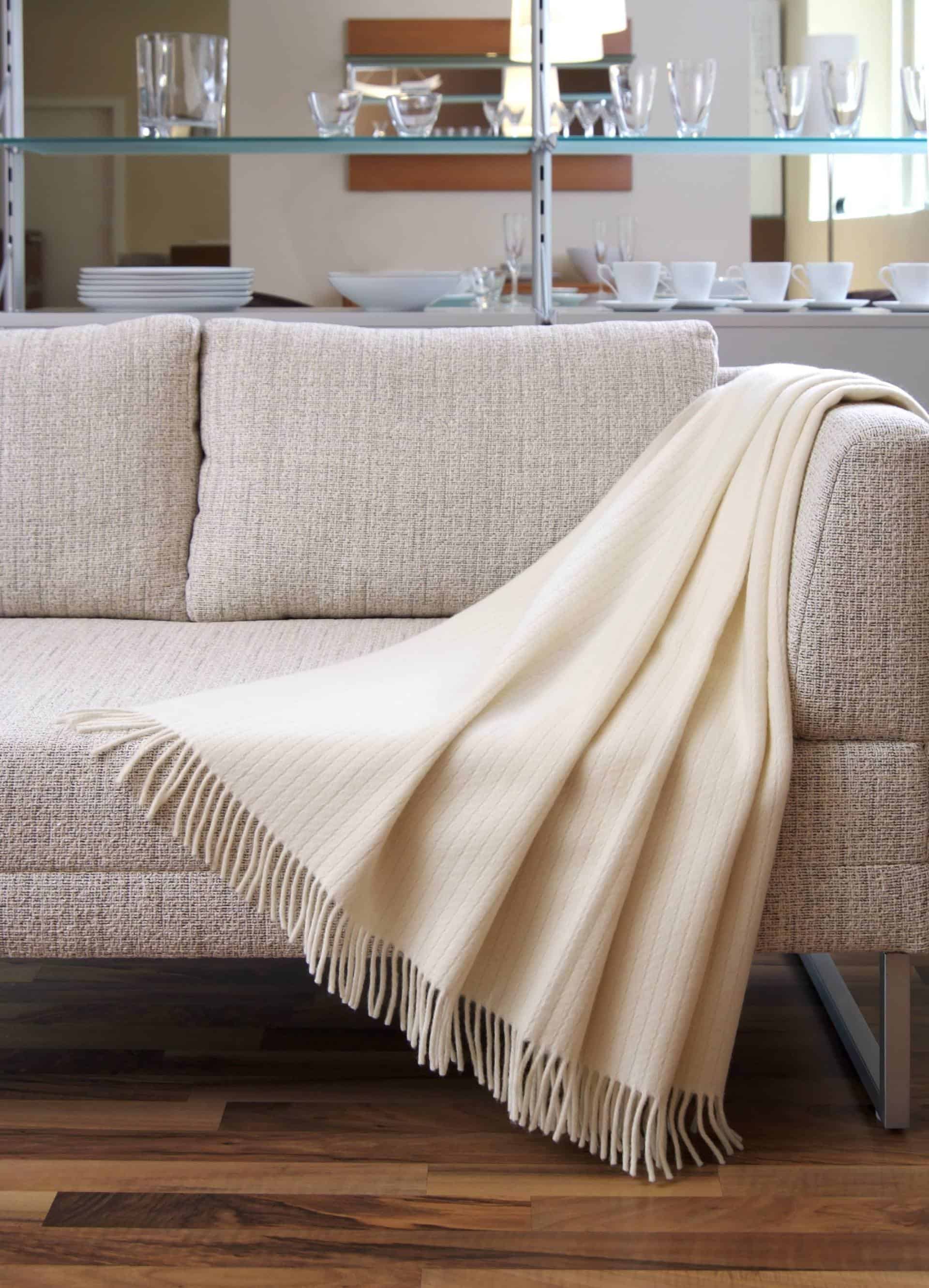 Blanket draped over a settee photo description example