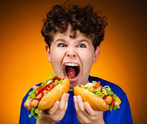 Boy eating hot dogs